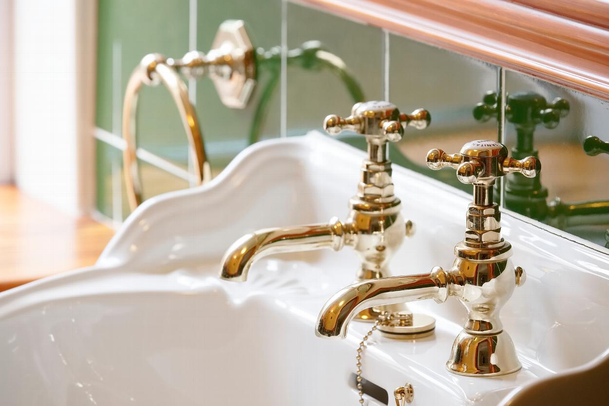 Bathroom sink with golden taps